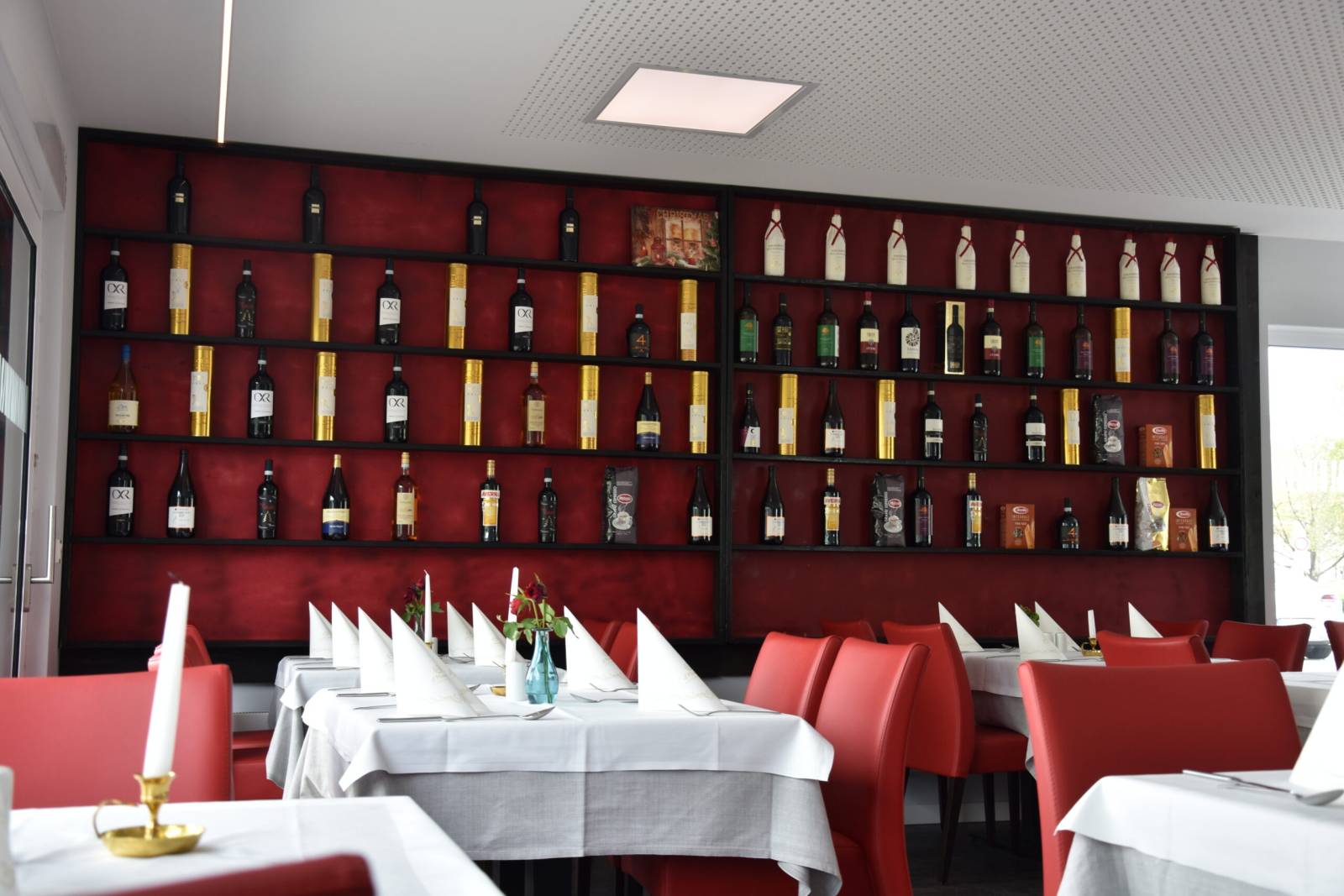 Dining room with wine wall and white tablecloths